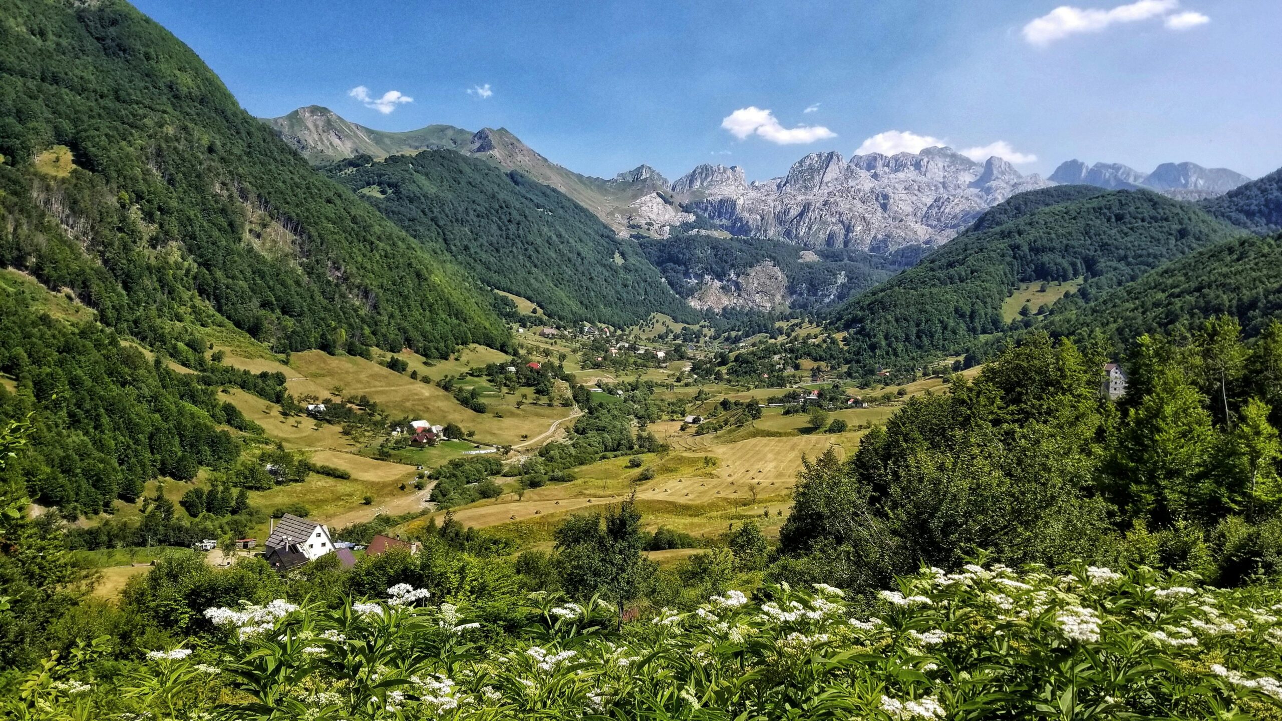 Panoramic view of the rugged Albanian Alps with green valleys and mountain peaks,