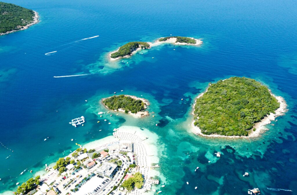 Ksamil beach with turquoise Ionian water and the four Ksamil Islands visible offshore, southern Albania
